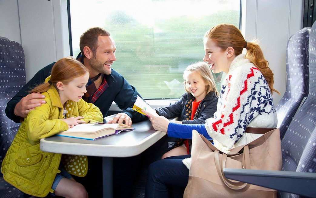 Family enjoying a train ride on Stansted Express from London Airport.