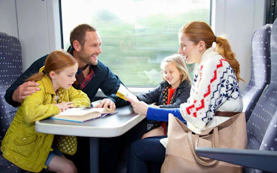 Family enjoying a train ride on Stansted Express from London Airport.