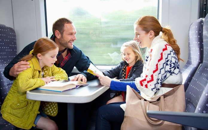 Family enjoying a train ride on Stansted Express from London Airport.