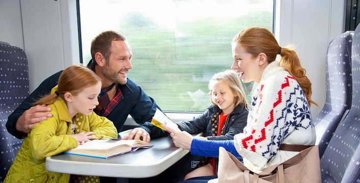 Family enjoying a train ride on Stansted Express from London Airport.