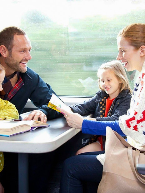 Family enjoying a train ride on Stansted Express from London Airport.