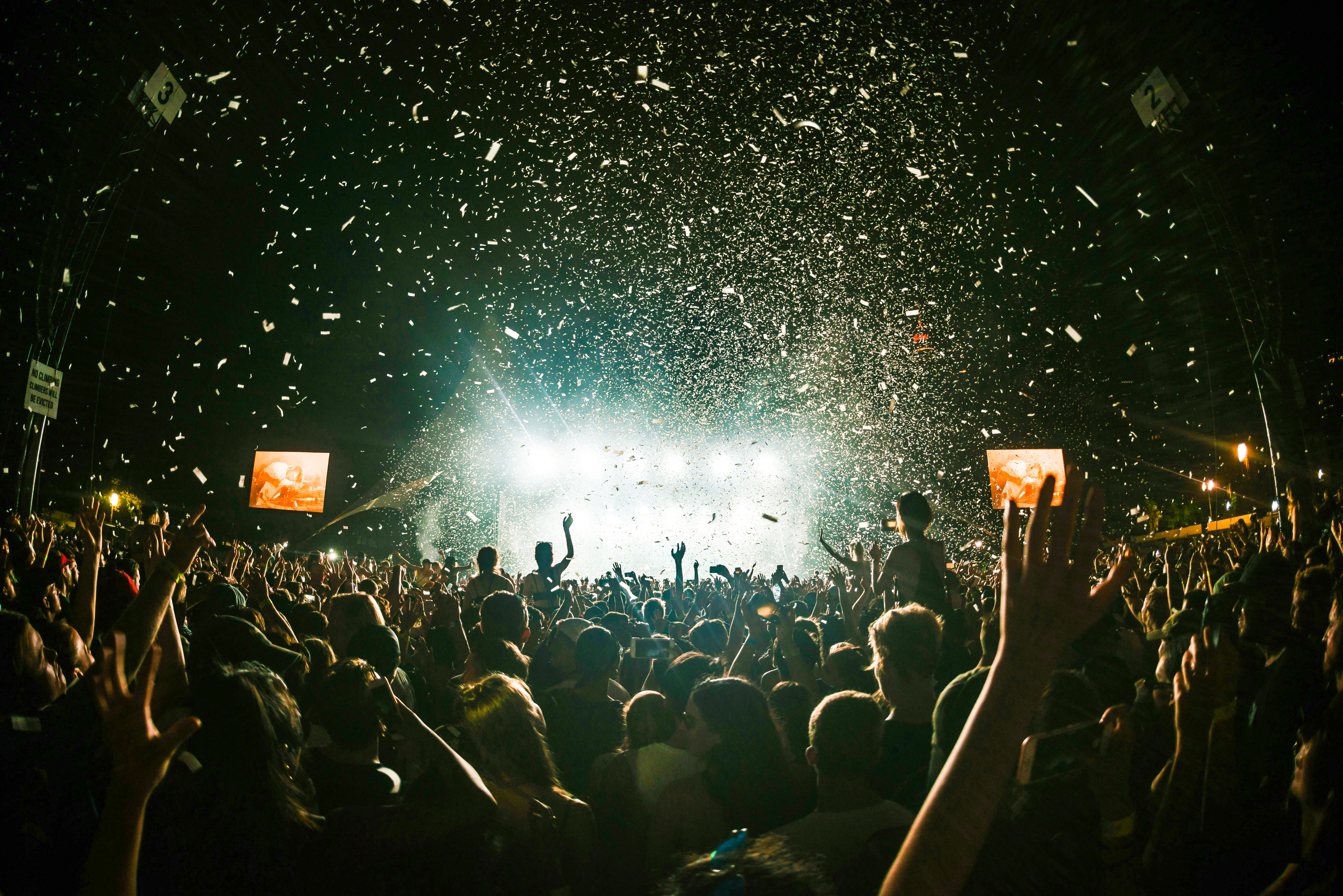 Crowd enjoying a night concert with confetti at Terra Solis by Tomorrowland.
