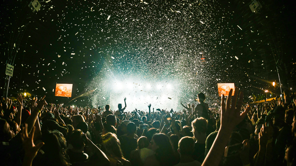 Crowd enjoying a night concert with confetti at Terra Solis by Tomorrowland.