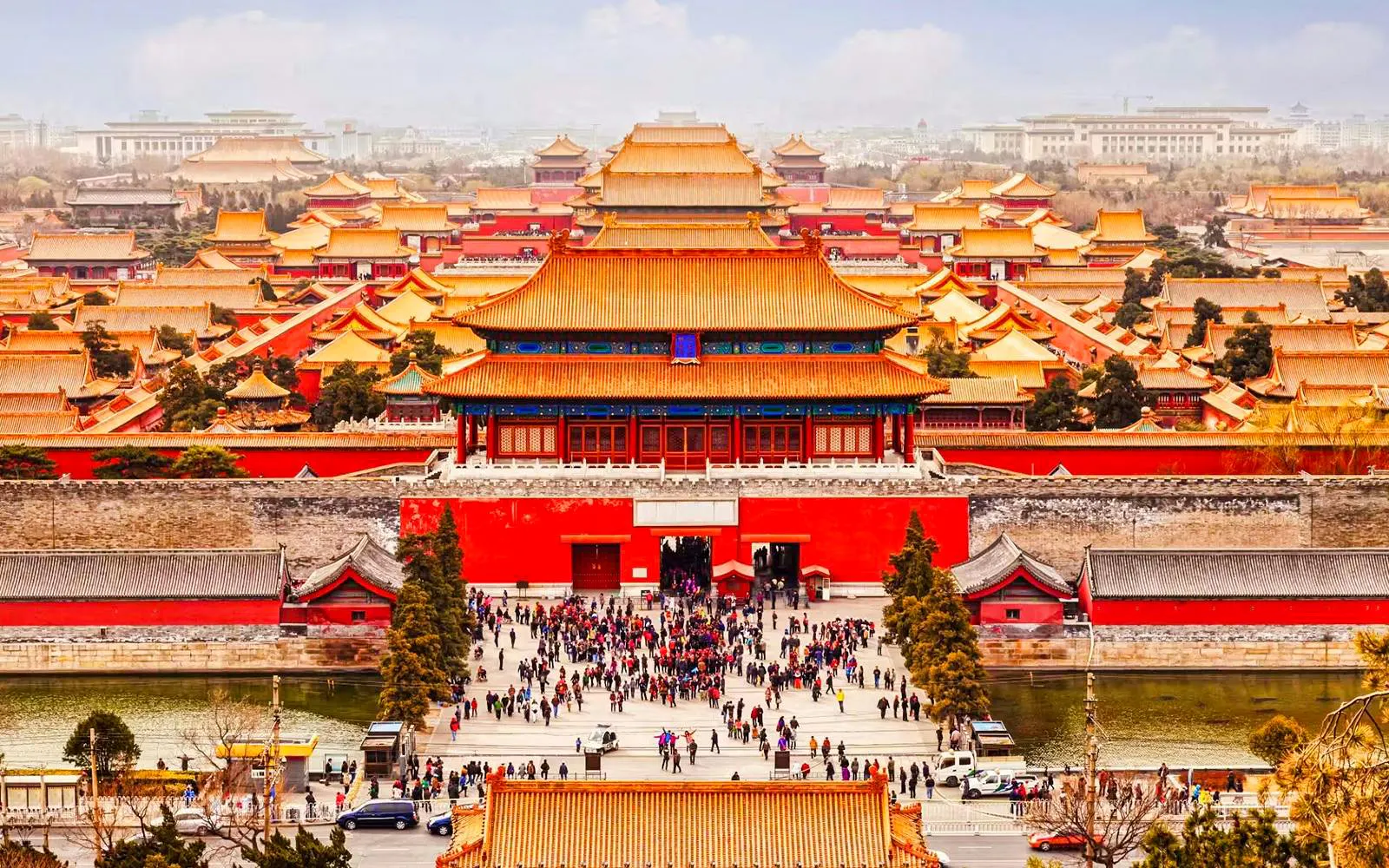 Elevated view of the Forbidden City in Beijing, China, with crowds and traditional architecture.