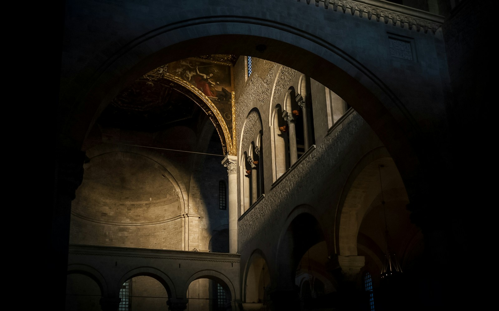 Dimly lit church attic with arches and ornate ceiling in New Orleans, haunted tour.