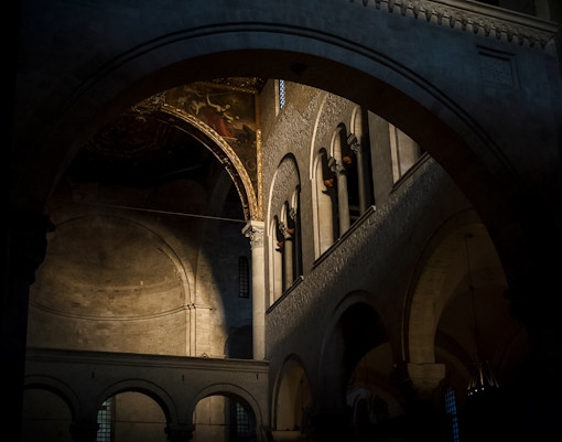 Dimly lit church attic with arches and ornate ceiling in New Orleans, haunted tour.