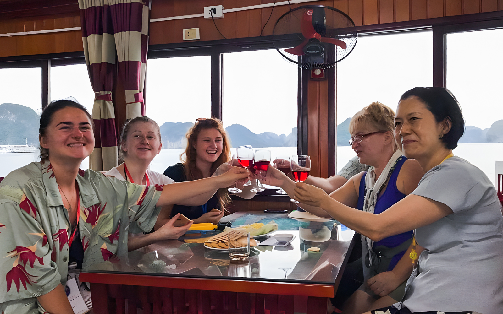Ha Long Bay cruise boat on emerald waters with limestone karsts, Vietnam.