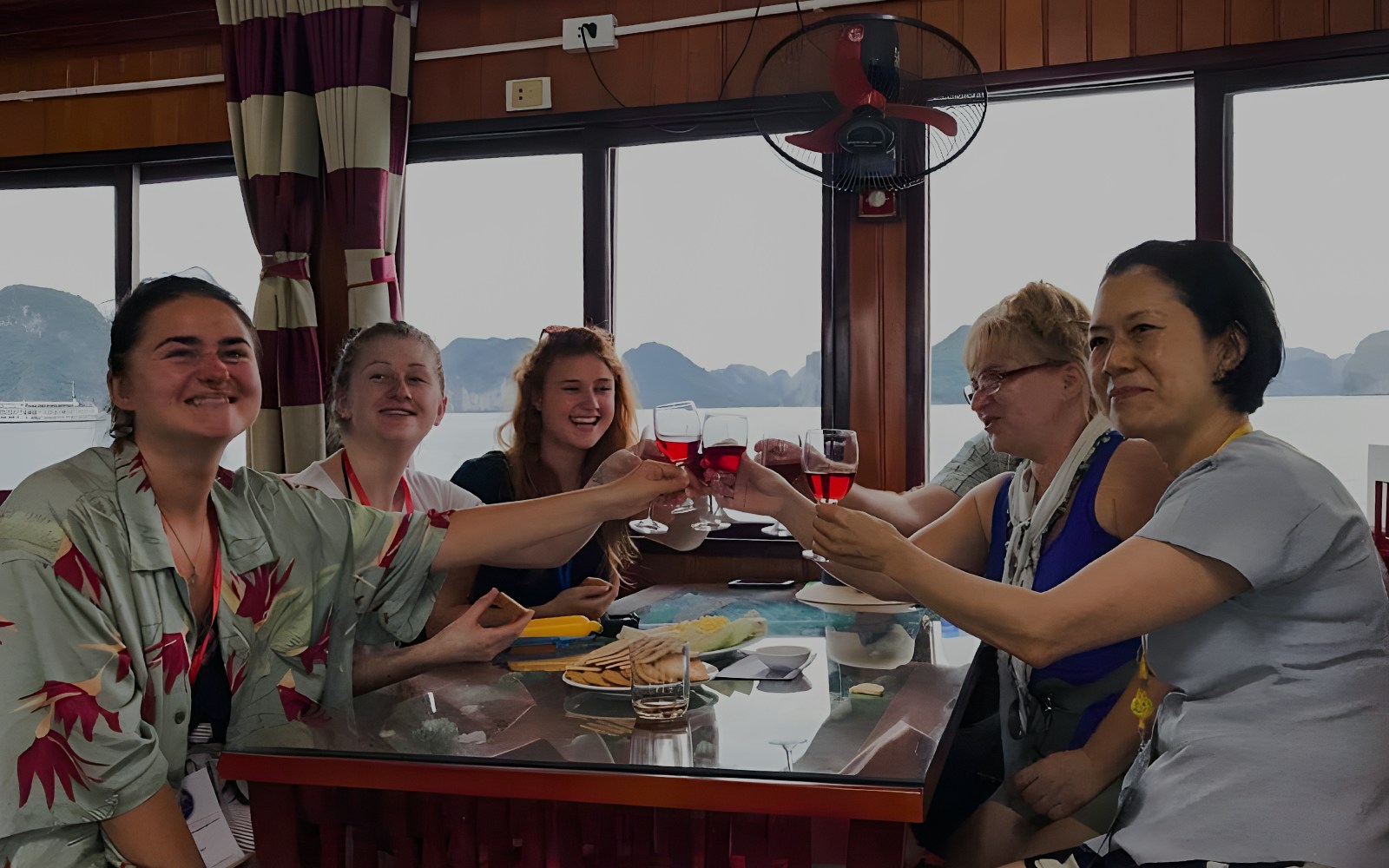 Ha Long Bay cruise boat on emerald waters with limestone karsts, Vietnam.