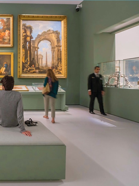 Tourists exploring art exhibits at the Louvre Museum Abu Dhabi.