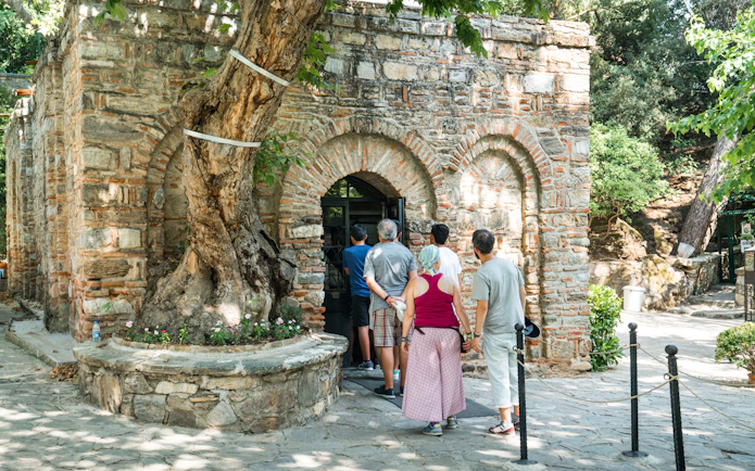 Visitors entering The House of the Virgin Mary, Ephesus, Izmir, Turkey.