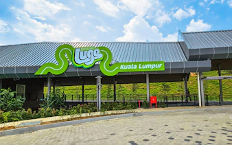 Skyline Luge Kuala Lumpur entrance with green signage and modern architecture.