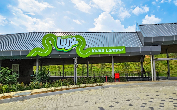 Skyline Luge Kuala Lumpur entrance with green signage and modern architecture.