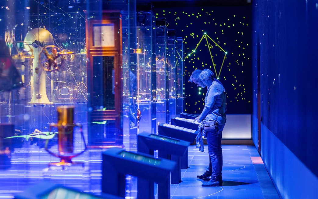 Visitor exploring interactive display at The Maritime Museum, Amsterdam exhibit.