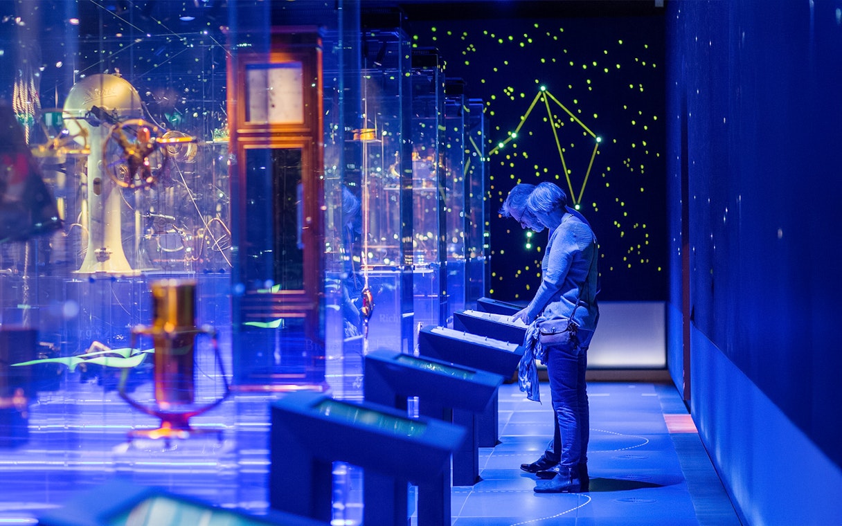 Visitor exploring interactive display at The Maritime Museum, Amsterdam exhibit.