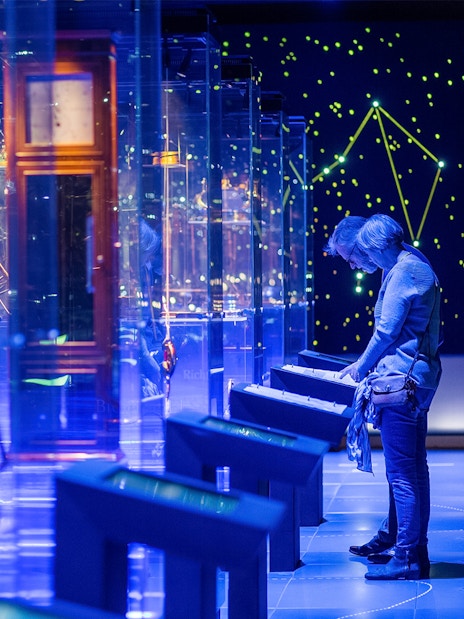 Visitor exploring interactive display at The Maritime Museum, Amsterdam exhibit.