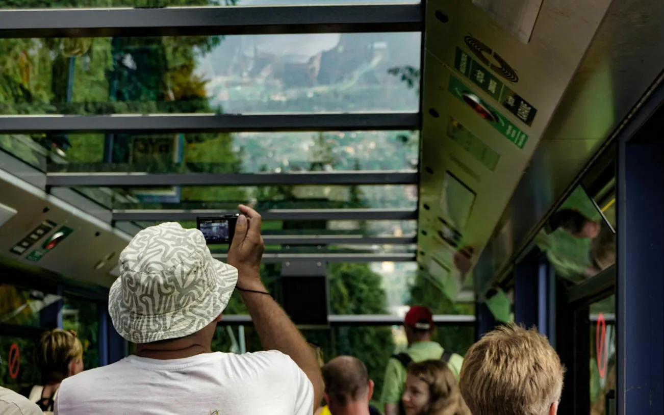 Tourists inside a cable car in Zakopane, capturing scenic views of the mountains.