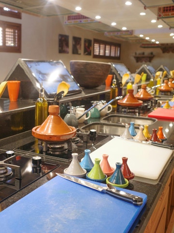 Cooking station with tagines and utensils at Moroccan Culinary Art Museum.