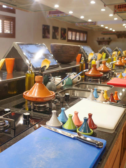 Cooking station with tagines and utensils at Moroccan Culinary Art Museum.