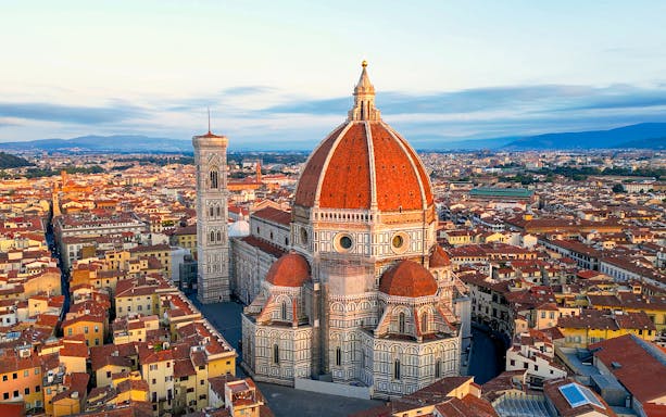 Duomo Florence at golden hour with cityscape in the background.