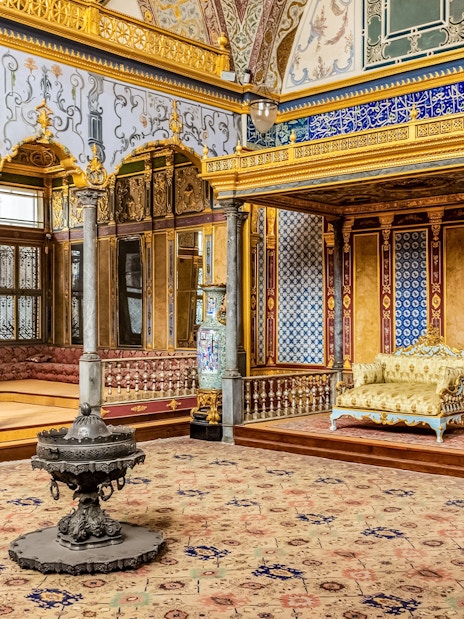 Topkapi Palace interior with ornate gold decorations and patterned tiles in Istanbul.