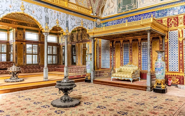 Topkapi Palace interior with ornate gold decorations and patterned tiles in Istanbul.
