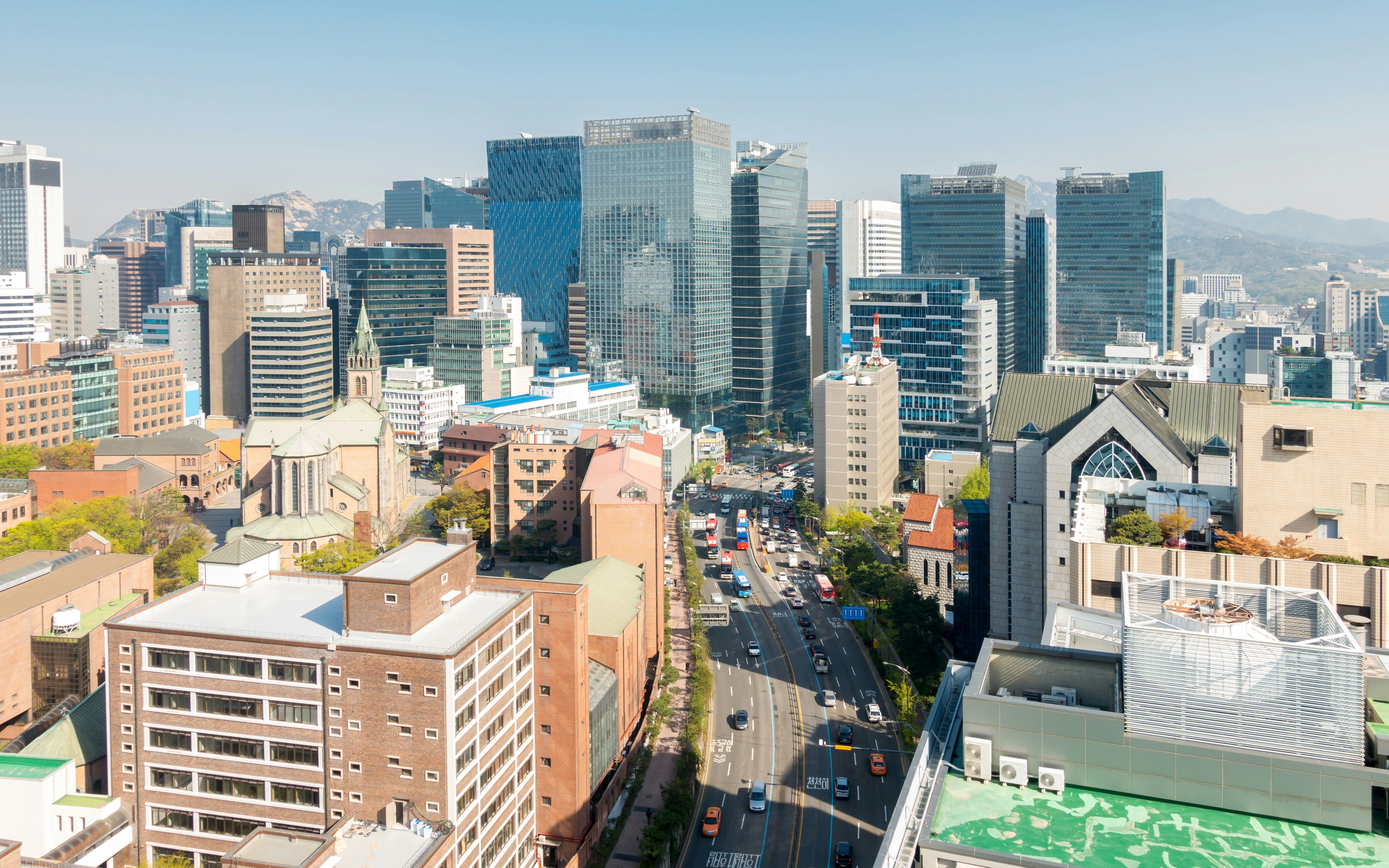 Myeongdong cityscape with modern skyscrapers and busy streets in Seoul, South Korea.