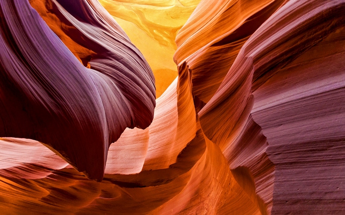 Aerial view of Antelope Canyon's swirling sandstone formations during a tour over Arizona.
