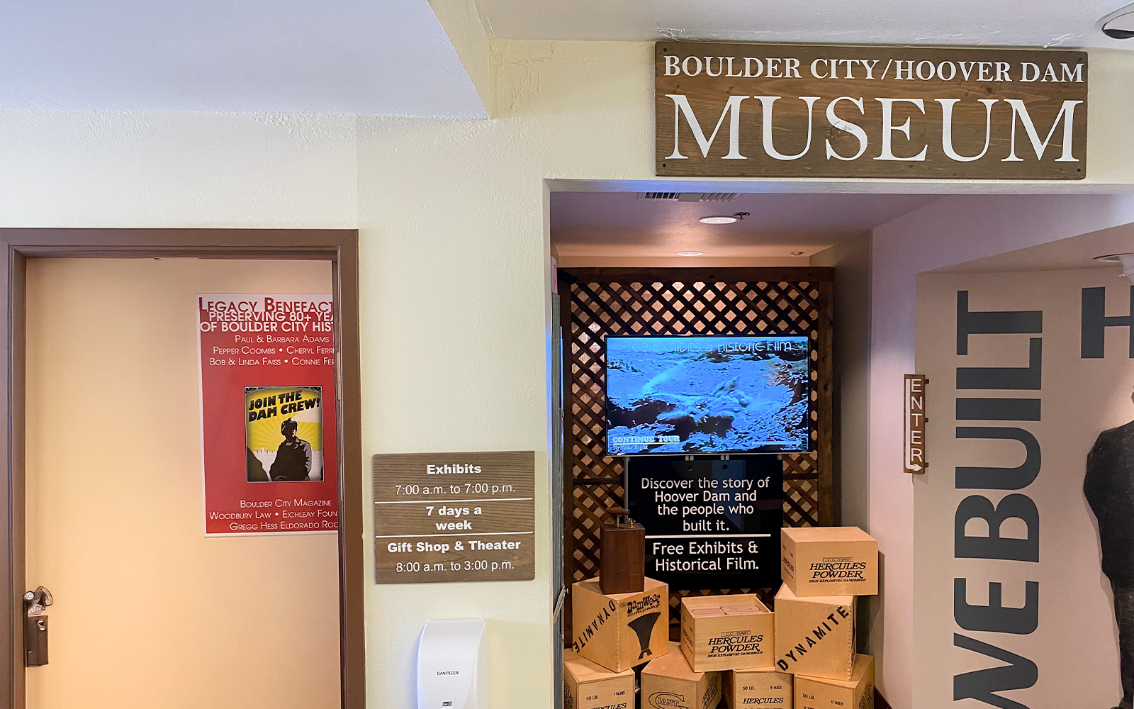 Boulder City Hoover Dam Museum entrance with exhibit hours and historical film display.