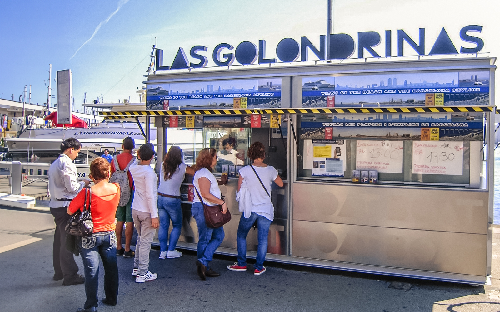 Visitors at Las Golondrinas ticket booth in Barcelona port.