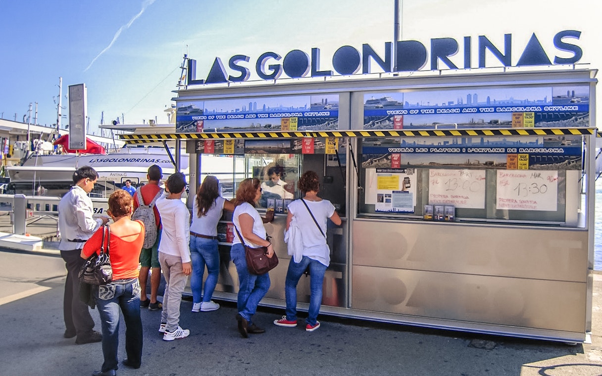 Visitors at Las Golondrinas ticket booth in Barcelona port.