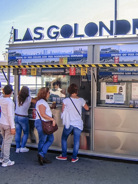 Visitors at Las Golondrinas ticket booth in Barcelona port.