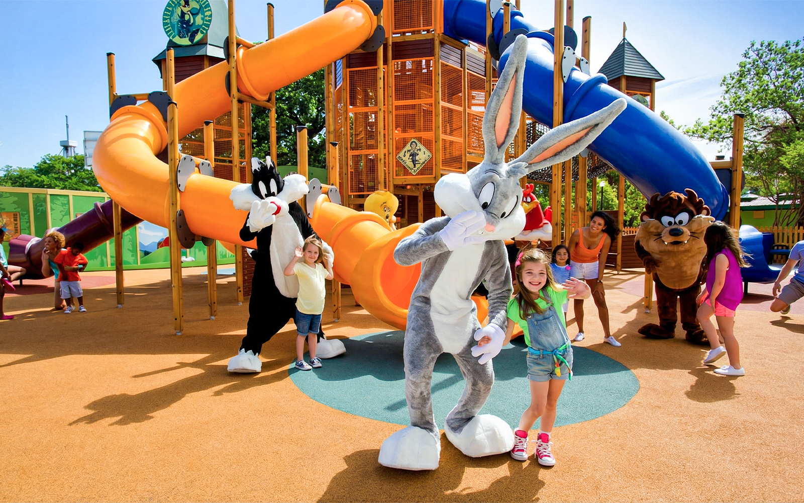 Children playing with LOONEY TUNES characters at Six Flags Over Texas Adventure Camp.