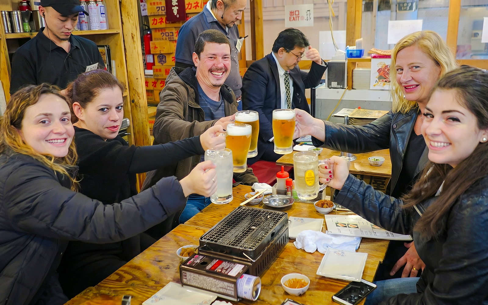 Group enjoying drinks at Shinjuku bar in Tokyo during a bar hopping tour.