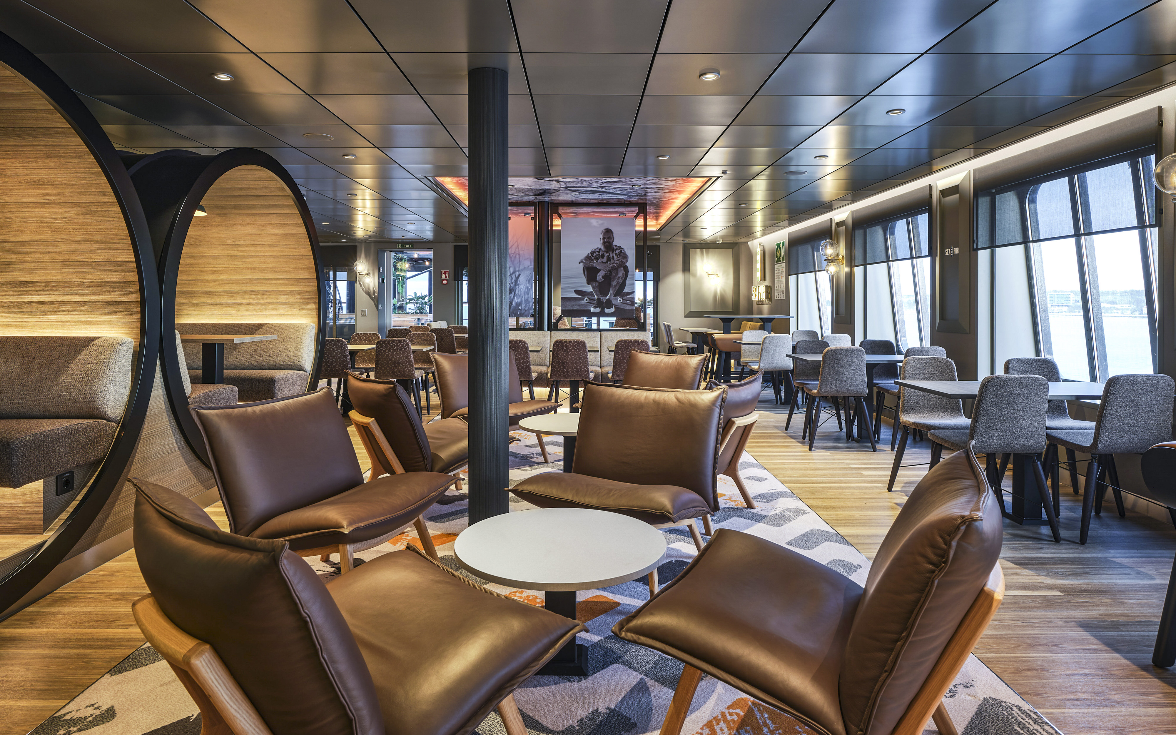 Modern ferry lounge with seating area on Helsinki to Tallinn route.