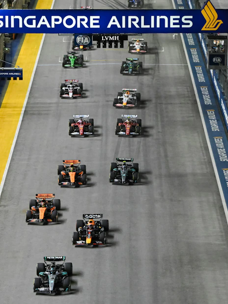 Cars racing on the track at Formula 1 Singapore Grand Prix night event.