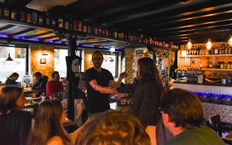 Bar scene in Reykjavik with a guide discussing punk music history during a private tour.