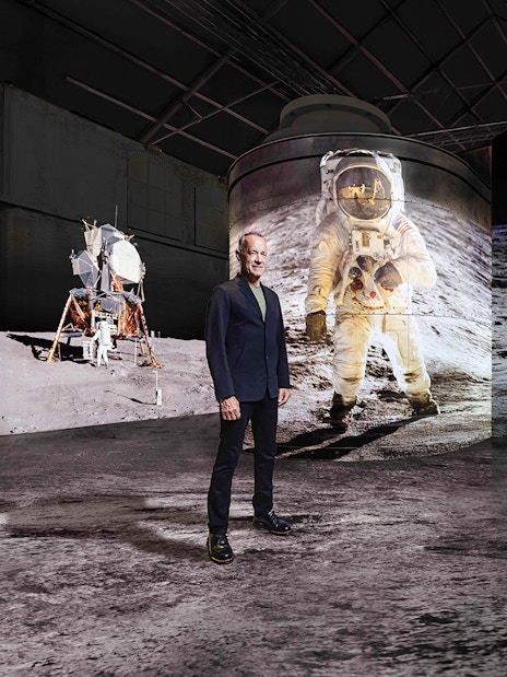 Visitor at Moonwalkers Exhibition, Fabrique des Lumières, Amsterdam, with lunar landing visuals.