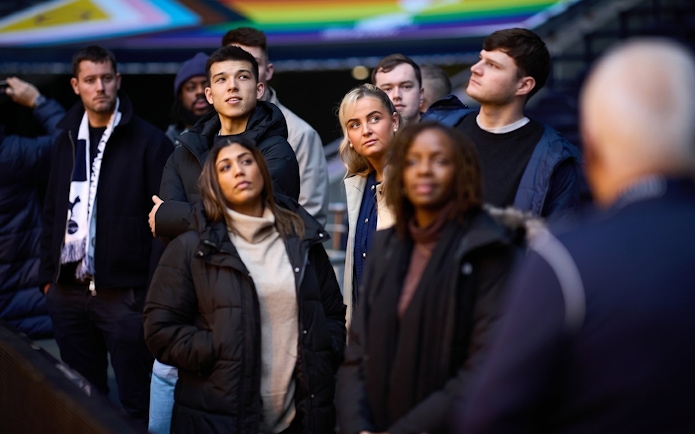 Group of people listening to a guide during the Tottenham Hotspur Stadium tour.