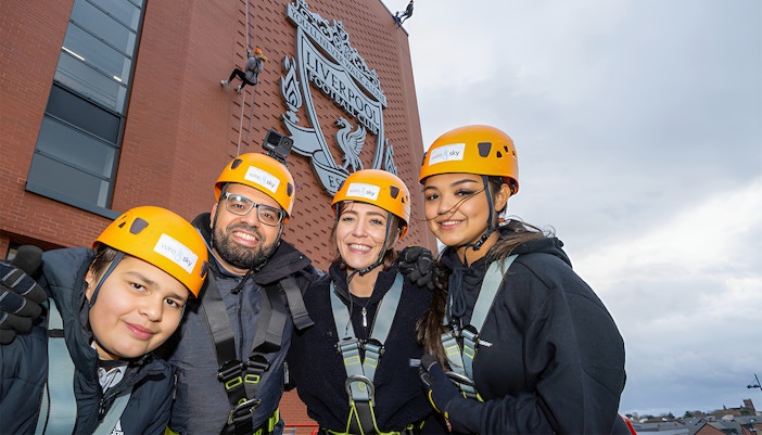 Tourists preparing for Anfield Abseil at Liverpool FC Stadium, a unique experience included with Museum Entrance Tickets