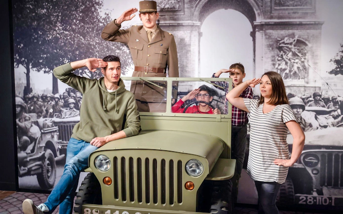 Visitors posing with a wax figure of a soldier at Grévin Wax Museum, Paris.