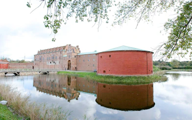 Malmö Castle with moat and reflection in Sweden.