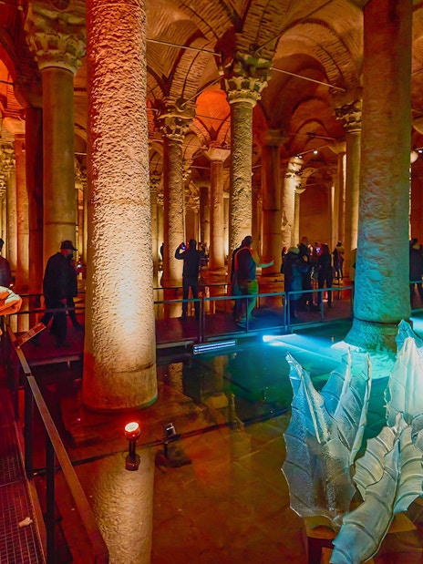 Visitors exploring the illuminated columns of the Basilica Cistern in Istanbul.