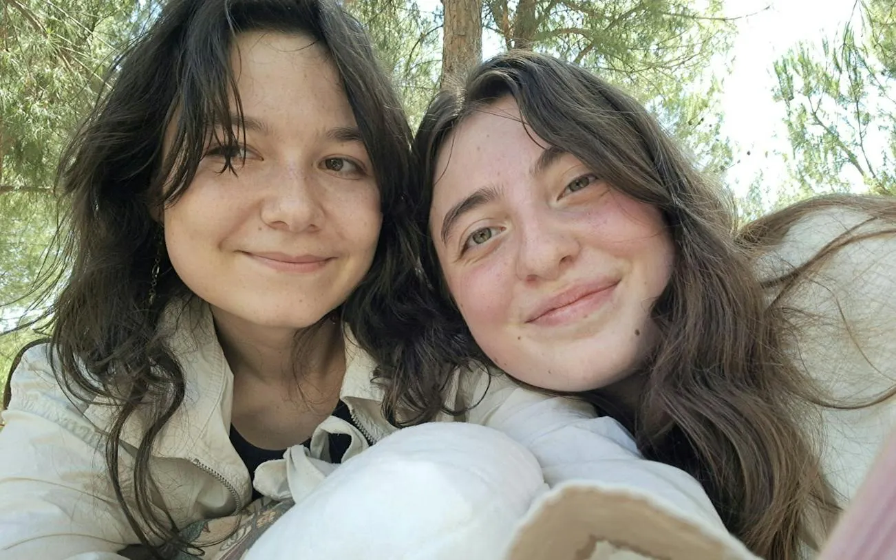 Two people smiling outdoors during a self-guided city exploration game in Madrid.