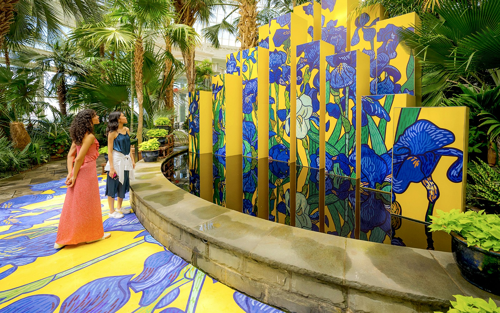 Visitors walking through the lush greenery of New York Botanical Garden.