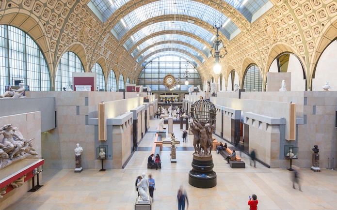 Orsay Museum interior with sculptures and ornate arched ceiling in Paris, France.