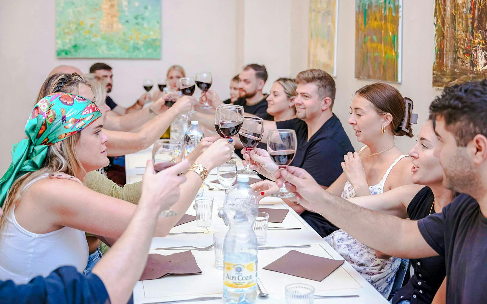 Small group toasting with wine during a cooking class in Florence.