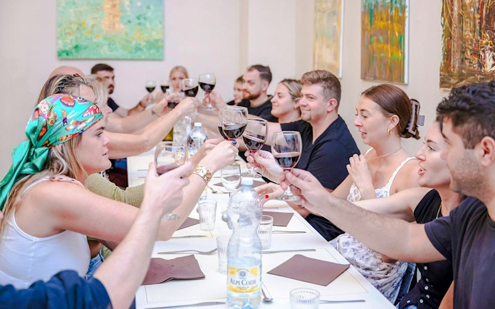 Small group toasting with wine during a cooking class in Florence.