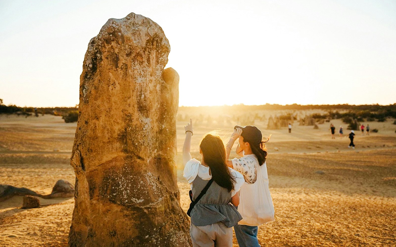 Visitors exploring Pinnacles Desert at sunset during stargazing and wildlife tour.