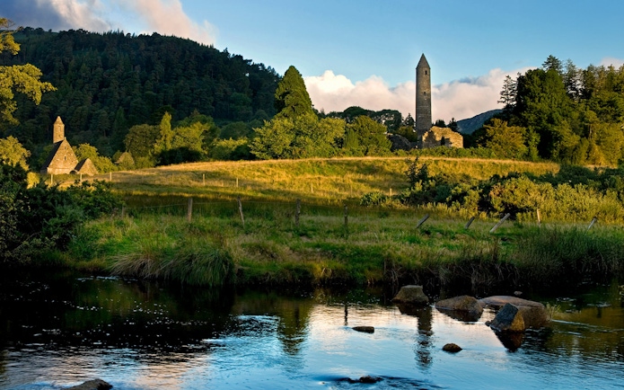 Wicklow National Park with ancient stone tower and lush green landscape.