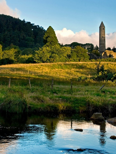 Wicklow National Park with ancient stone tower and lush green landscape.